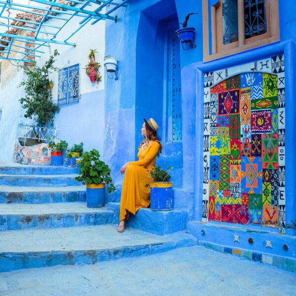 A woman in the blue city of Morocco during the day trip from Fes.