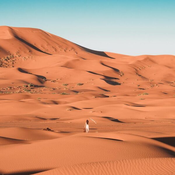 A woman in the middle of the Sahara desert of Morocco.
