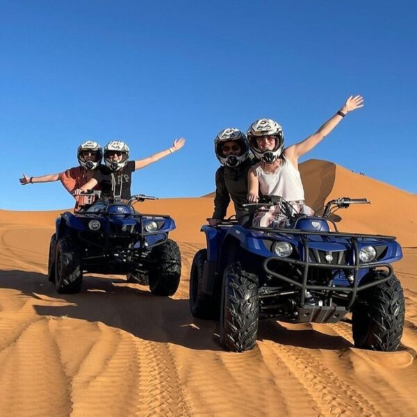 4 people riding quads in Merzouga desert.