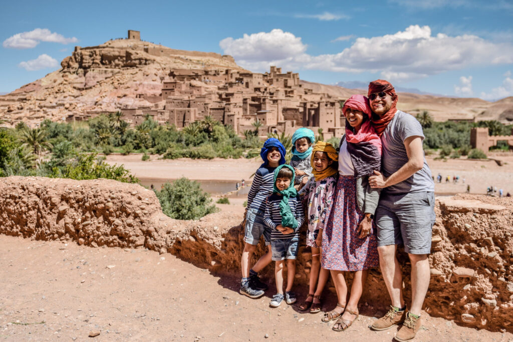 A family traveling in Morocco, a fortress in the background