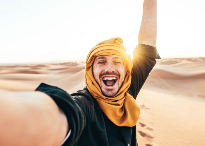 Happy person in the desert of Morocco during our 4-day tour from Casablanca