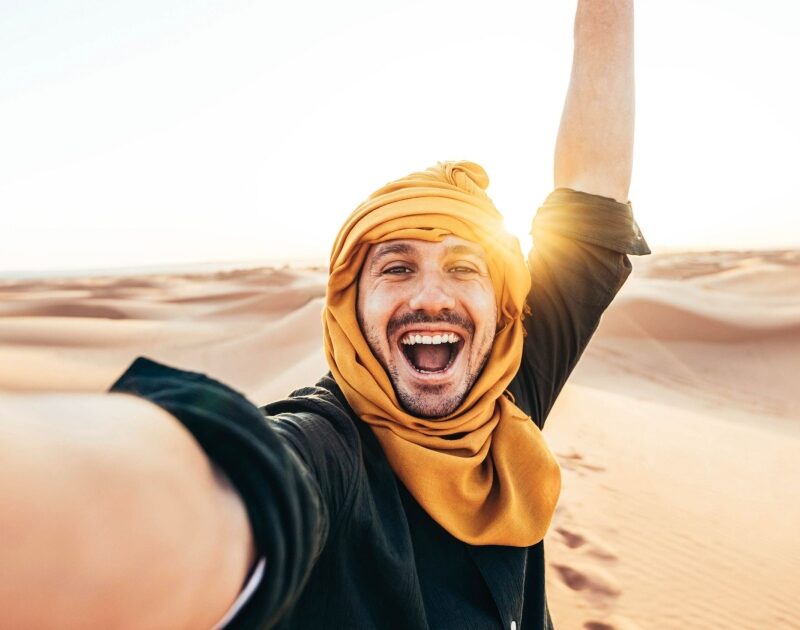 Happy person in the desert of Morocco during our 4-day tour from Casablanca
