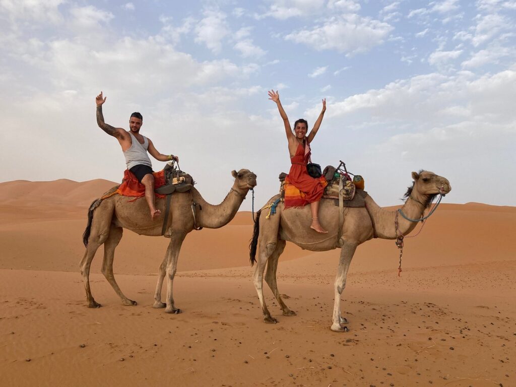 Camel ride of a couple in the desert of Morocco