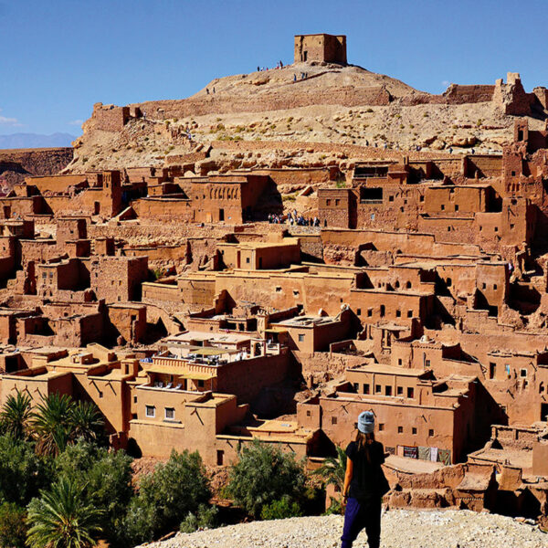 A traveler admiring the view of the Kasbah of Ait Benhaddou.