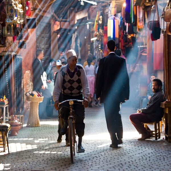 a man riding a bicycle in the markets of Marrakech.