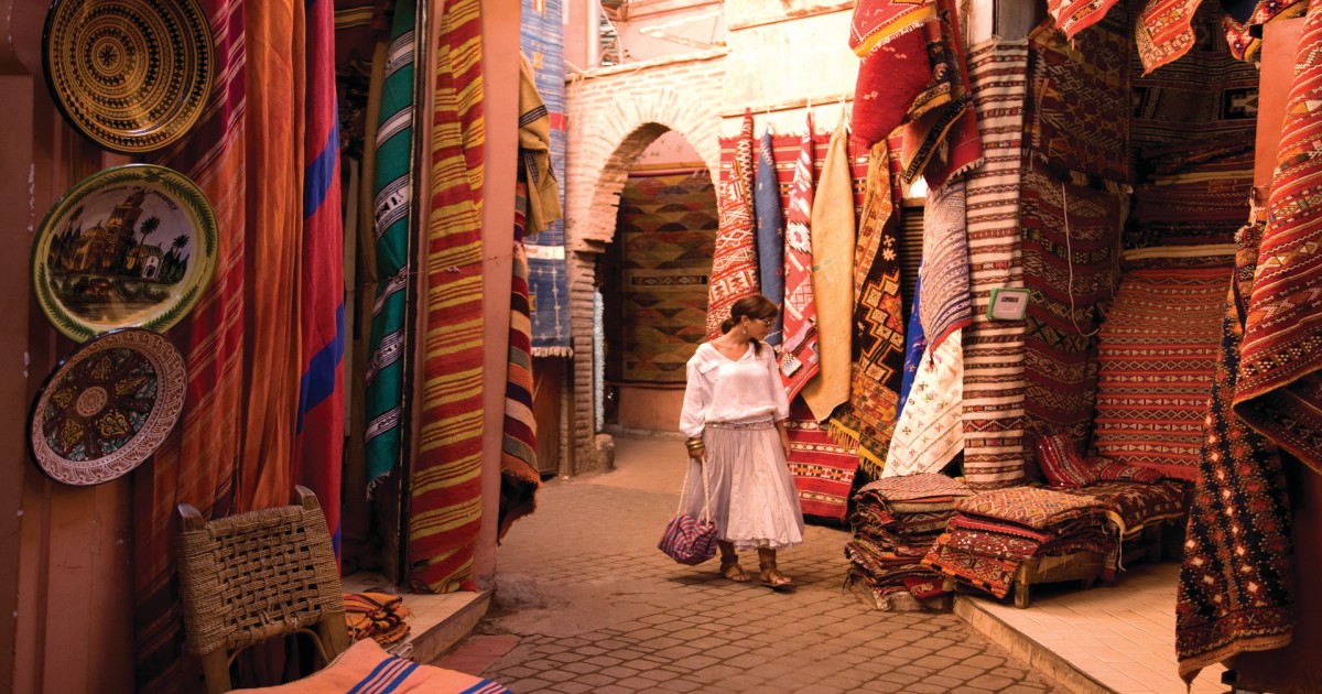 Medina of Marrakech and a woman looking to buy carpets