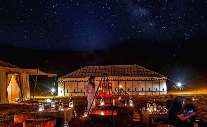 A desert camp in Merzouga at night during the 3-day tour from Agadir to Fes.