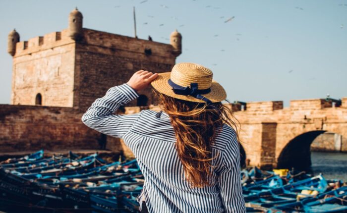 A woman with a hat on the seaport during the Marrakech to Essaouira day trip.